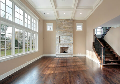 Family room in new construction home with two story fireplace